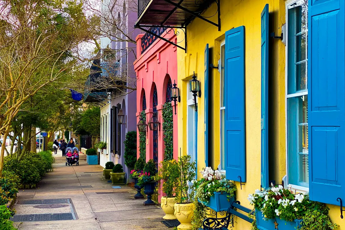 Colorful Charleston row houses with blue shutters and window boxes